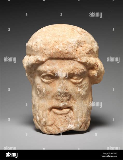 Marble herm head of a bearded deity .